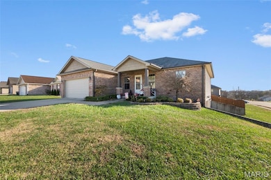 View of front of home featuring covered porch, brick siding, concrete driveway, and a garage