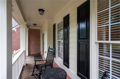 Cozy front porch with space for rocking chairs — perfect for relaxing.