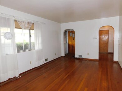 Spacious living room with original hardwood floors