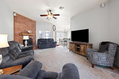 Carpeted living room featuring a fireplace and cei