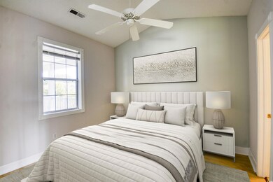 Bedroom with light wood-type flooring, ceiling fan
