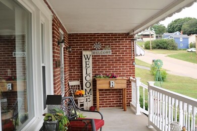 Spacious yet cozy front porch welcomes you.