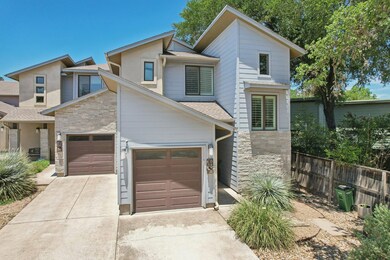 View of front of property with stone siding, driv