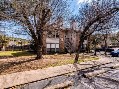 View of front of property with a chimney, brick s