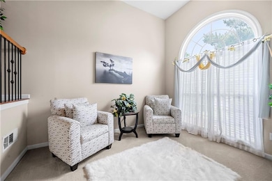 Sitting room with carpet flooring and baseboards