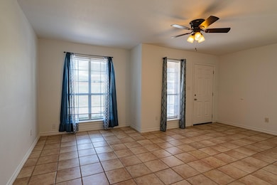 Empty room with light tile patterned floors and ce