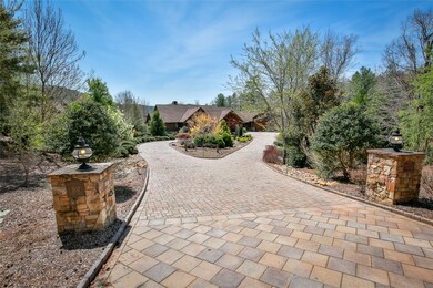 Pavers line the circular drive wit flagstone apron