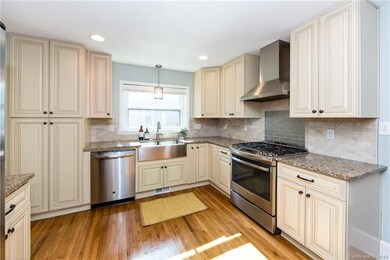 Kitchen with granite counters, custom cabinetry, a