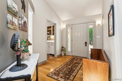 Entrance foyer with lofted ceiling and light tile