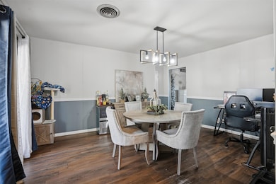 Dining room featuring dark wood-style floors