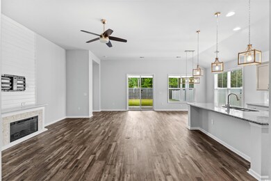 Unfurnished living room with ceiling fan, lofted c