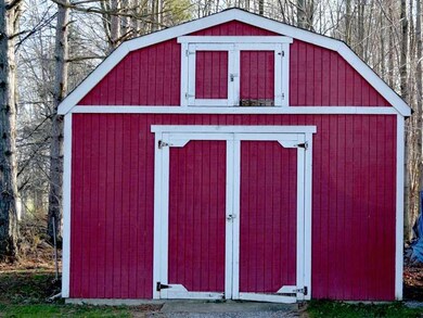 Storage. The barn like storage shed is included