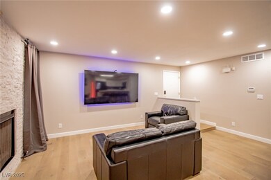 Living room with light wood-style floors, recessed