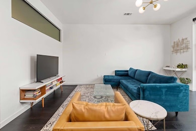 Living area featuring dark wood-style floors and 