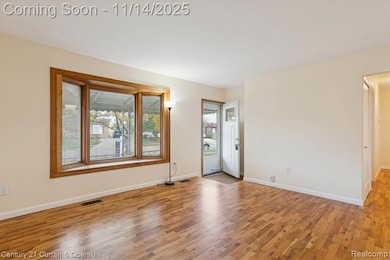 Spare room with light wood-style floors and baseboards