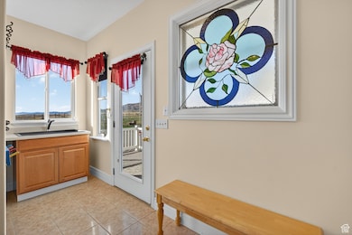 Doorway featuring tile patterned floors and a sink.