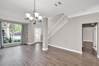 Foyer entrance featuring ornamental molding, dark