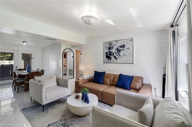 Living area featuring marble finish flooring, wood