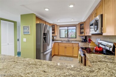 Kitchen with sink, light stone counters, kitchen p