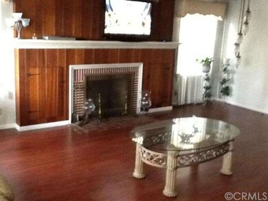 Living room with wood burning fireplace and wood f
