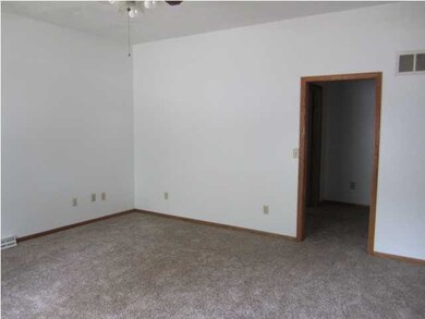 Large living room has newer carpet and large windo