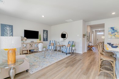 Living area featuring wood finished floors and recessed lighting