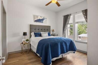 Bedroom featuring wood finished floors, baseboard