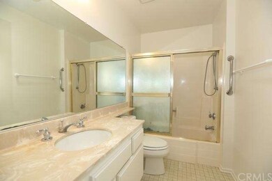 The bathroom has fresh paint and a hand grip for t