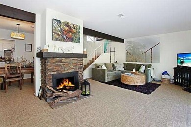 Main Home: Living room with fireplace and beamed c