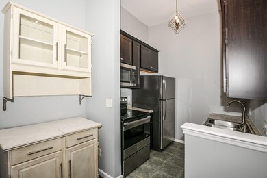 The galley kitchen is finished with a ceramic tile