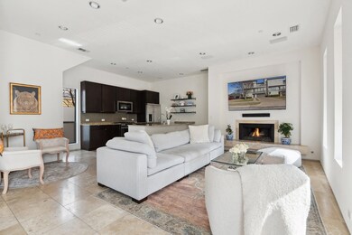 Living area with recessed lighting and a warm lit fireplace