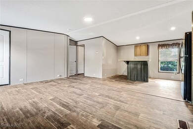 Unfurnished living room featuring a textured ceili