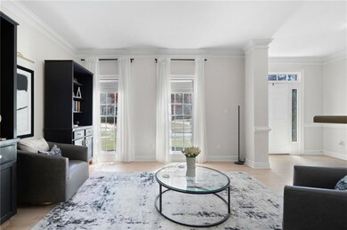 Living area with light wood finished floors, baseb