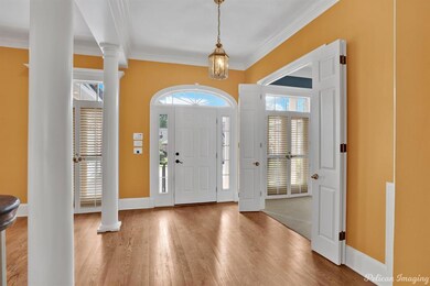 Entry with wood floors and leads to the formal din