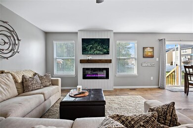 Great room with electric fireplace and view to woo