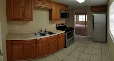 Kitchen looking into living room entrance