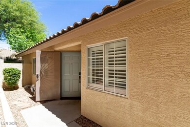 View of exterior entry with stucco siding and a ti