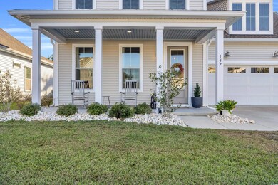 Doorway to property with a garage, covered porch, 
