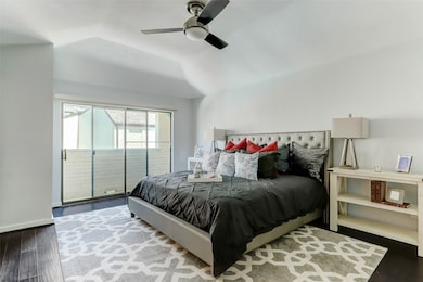 Spacious master bedroom features a vaulted ceiling