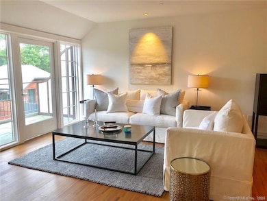 The living room and entrance to the balcony. Furnishings are from a prior tenant.