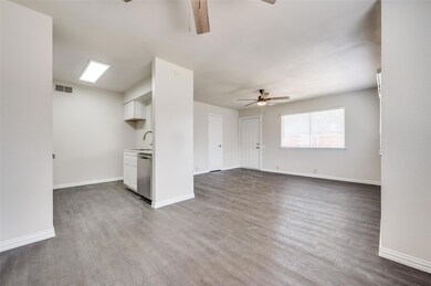 Unfurnished living room with ceiling fan, wood-typ