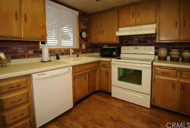 Dishwasher, electric range, and lots of cabinetry.