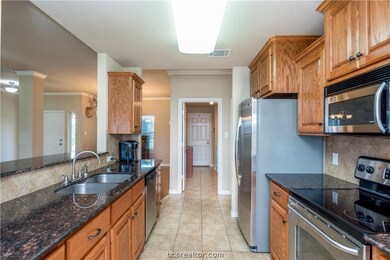 Kitchen features granite counters, tile flooring a