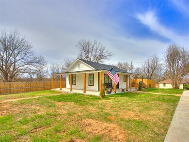 Bungalow-style home featuring a front yard, fence, and a patio area
