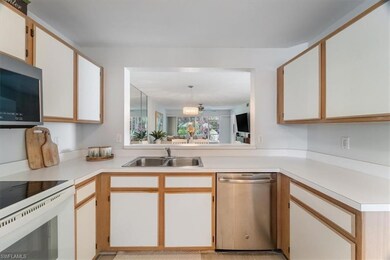 Kitchen featuring appliances with stainless steel finishes and light countertops