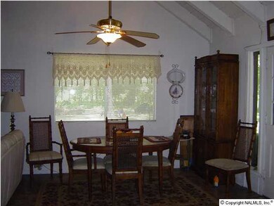 15' x 13' dining room area with a vaulted ceiling and a ceiling fan.