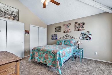 Carpeted bedroom featuring a ceiling fan, baseboar