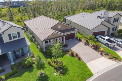Front of house, paver driveway, lush landscaping.