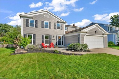 View of front property with garage and a front lawn