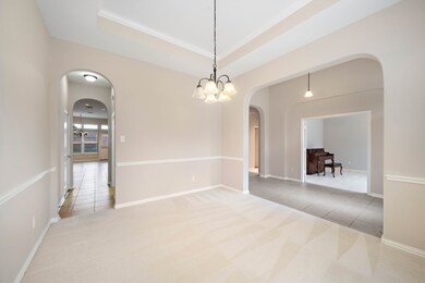 The formal living room is adjacent to  the front hall and kitchen.